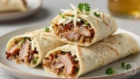 Gesneden wraps met pulled pork en coleslaw, mooi gepresenteerd.