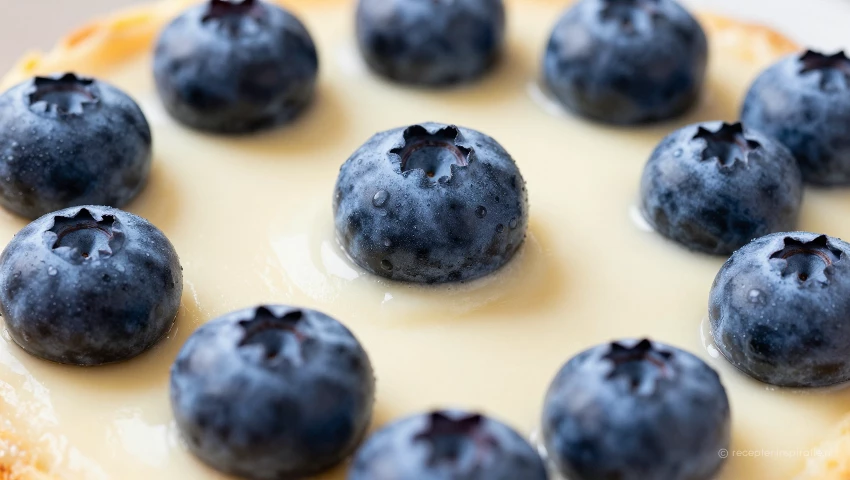 Verse bosbessen op romig beslag, close-up, realistisch.